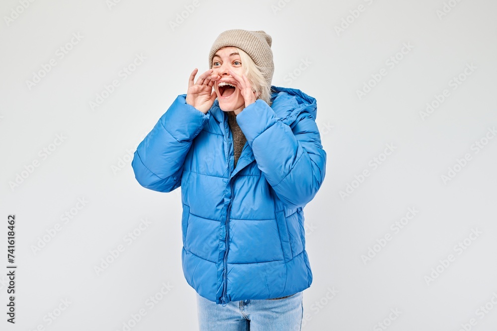 Portrait of blonde girl shouting loudly with hands, news, palms folded like megaphone isolated on white background Portrait of blonde girl shouting loudly with hands, news, palms folded like megaphone isolated on white background