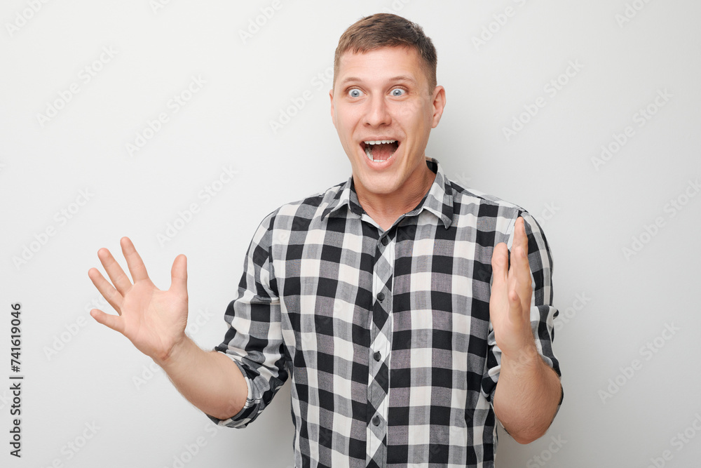 Portrait man happy face smiling joyfully with raised palms and shocked open mouth isolated on white studio background. Portrait man happy face smiling joyfully with raised palms and shocked open mouth isolated on white studio background.