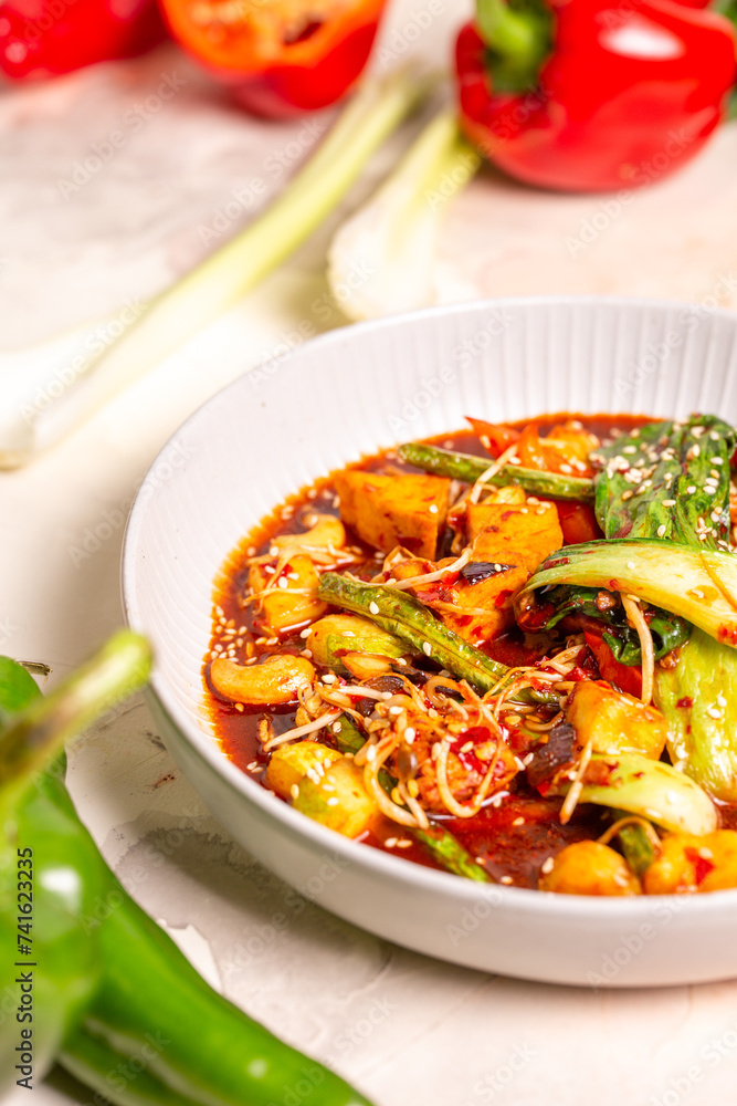 Bowl of red curry with vegetables and tofu on white background Bowl of red curry with vegetables and tofu on white background