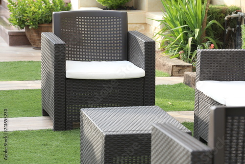 Modern garden furniture set of rattan inside the patio of the house photo