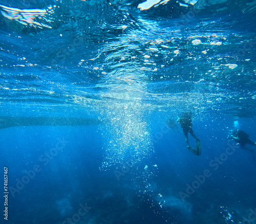 oxygen bubbles in the ocean from scuba divers, aquatic undersea background photo