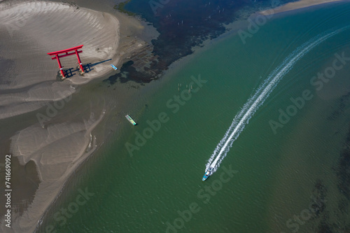 Aerial view of a motorboat sailing near Torii Gate along Lake Hamana, Hamanako Brackish Lagoon, Shizuoka, Japan. photo