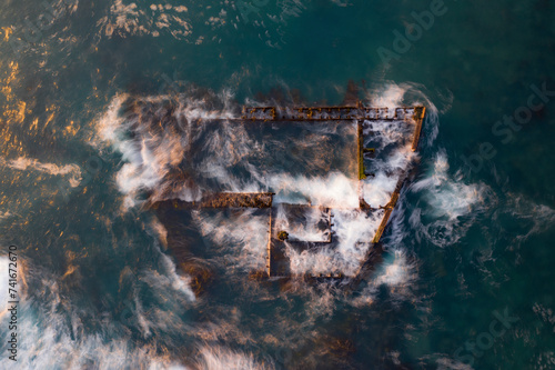 Aerial view of the Antipolis ship wreck with water rippling around it, taken with a long exposure, Cape Town, Western Cape, South Africa. photo