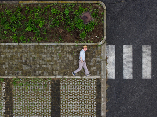 Aerial view of a person laying down on the ground walking into the unknown, Tortona, Piedmont, Italy.