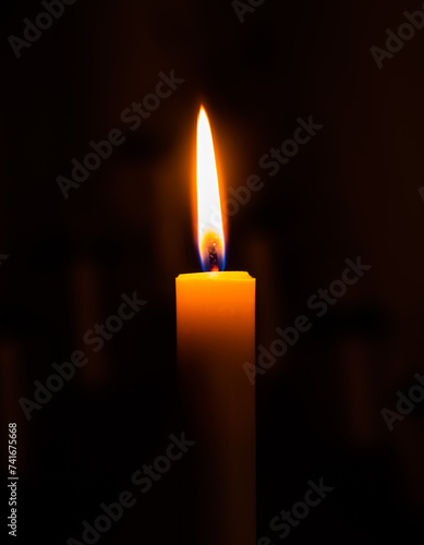 Burning candle on a black background (Candle flame)