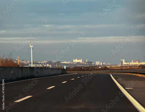 Road from Vienna to Bratislava. Panorama of Bratislava on the horizon.