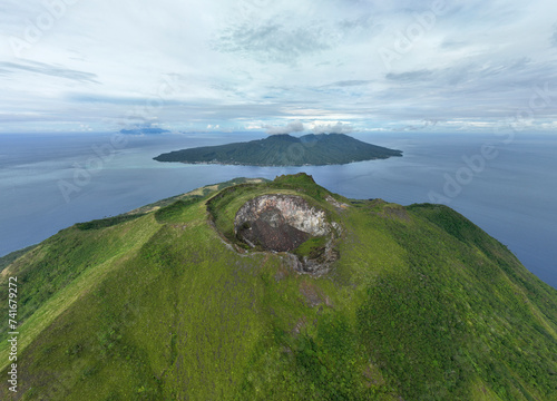 Aerial View of Ruang Volcano crater next to Tulandang Island, Indonesia. photo