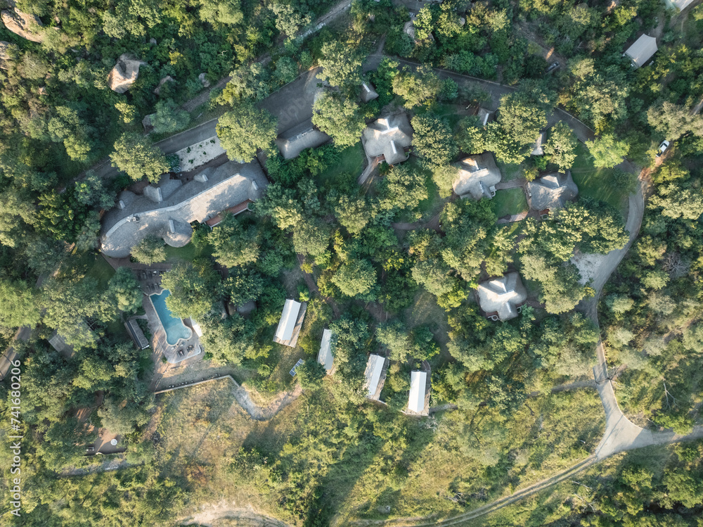 Aerial view of luxury resort swimming pool in the south African savanna ...