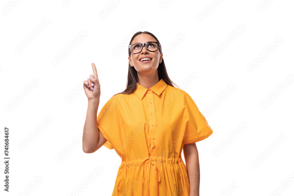 european young brunette lady wearing an orange summer dress and glasses smiling cutely on a white background european young brunette lady wearing an orange summer dress and glasses smiling cutely on a white background