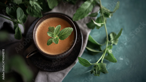 Professional Close-up of a Cup of Coffe on a little Plate with a Plant of Stevia next to it. Keto Friendly, Keto Diet Beverage. photo