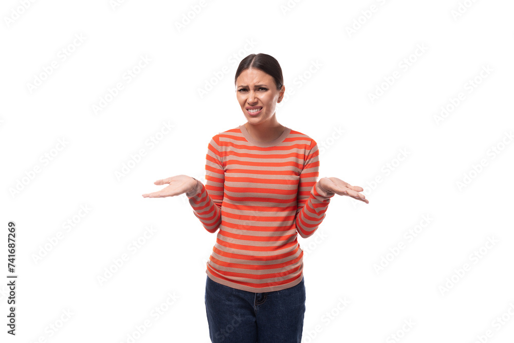 caucasian young black-haired woman dressed in an orange jacket shrugs her shoulders caucasian young black-haired woman dressed in an orange jacket shrugs her shoulders