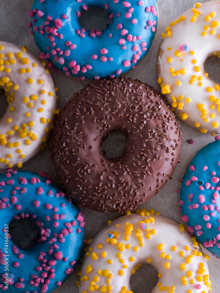 Sweet colorful donuts with a various sprinkles. Fat Thursday celebration. Flat lay.