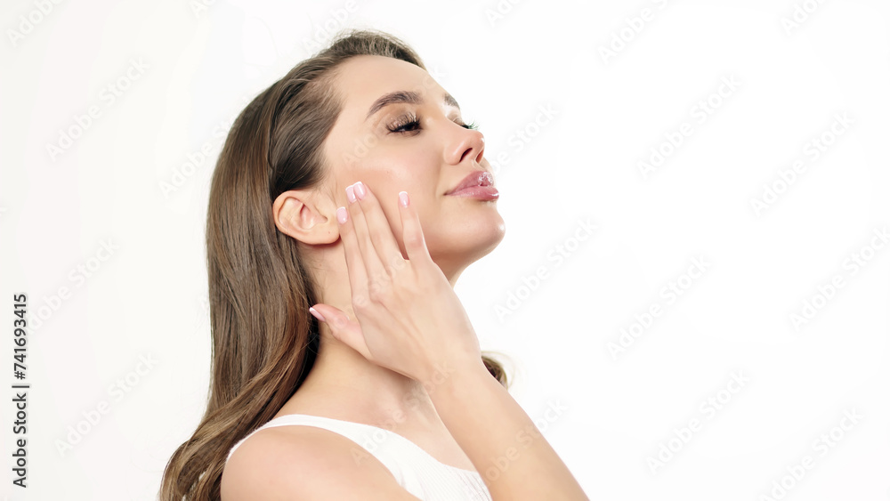 Beautiful young woman with clean fresh skin touching her own face. Facial treatment. Cosmetology, beauty and spa. Beautiful young woman with clean fresh skin touching her own face. Facial treatment. Cosmetology, beauty and spa.