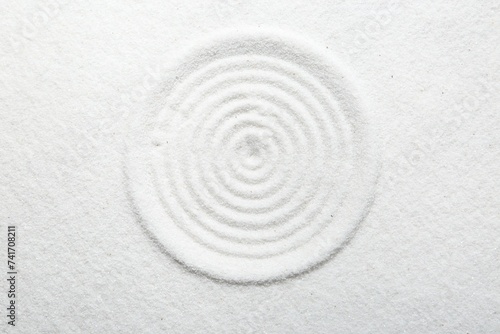 Photography Zen rock garden. Circle pattern on white sand, top view