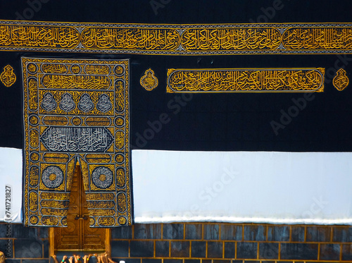 The golden doors of the Holy Kaaba closeup, covered with Kiswah. Massive lock on the doors. Entrance to the Kaaba in Masjid al Haram photo