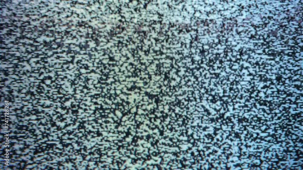 Close-up view of a television screen displaying static noise. Close-up view of a television screen displaying static noise.