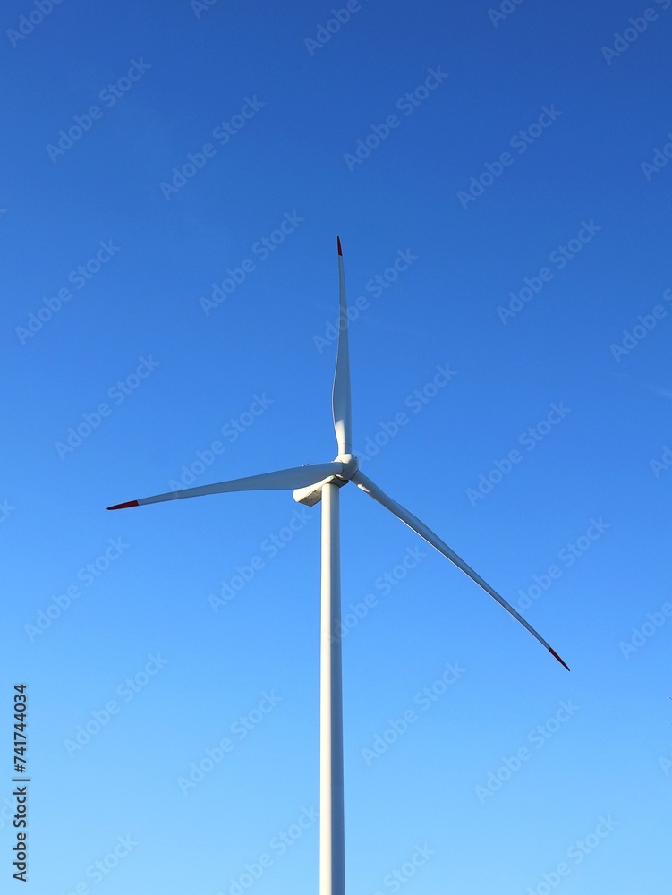 Windmill to generate energy. Wind turbine and a blue sky. Windmill to generate energy. Wind turbine and a blue sky.