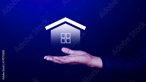 Real estate concept  Businessman holding home icon  Property insurance and security concept  Protecting gesture and symbol house. Real estate agent providing home.