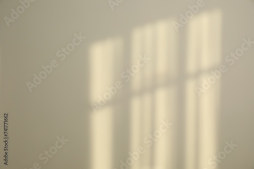 Light and shadows from window on wall indoors