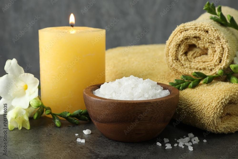 Composition with different spa products and burning candle, closeup