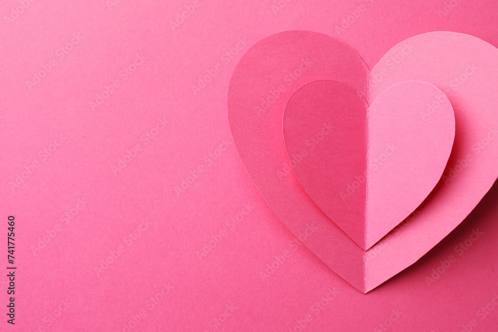 Paper hearts on pink background, top view. Space for text Paper hearts on pink background, top view. Space for text
