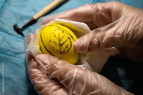 Painting Easter eggs with wax and creating patterns. Ukrainian traditions for Easter