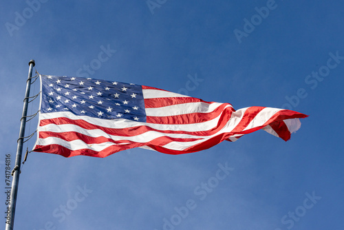 american flag flying in the sky off flag pole