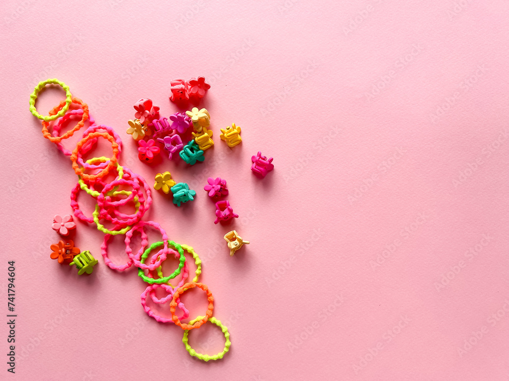 A set of accessories for a little girl on a pink background. Hairpins, comb, hair bands. Fashionable hair accessories for little girls. Flat styling. Top view A set of accessories for a little girl on a pink background. Hairpins, comb, hair bands. Fashionable hair accessories for little girls. Flat styling. Top view
