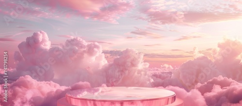 pink podium with a round glass top on pink clouds photo