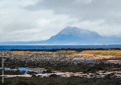 View during auto trip in West Iceland highlands, Snaefellsnes peninsula, Snaefellsjokull National Park. Spectacular volcanic tundra landscape with mountains, craters, rocky ocean coast.