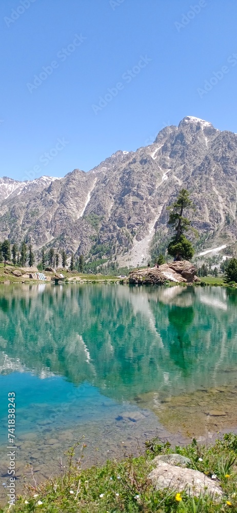 Stunning Reflection of Rocky Mountains in Crystal Clear Waters of Rainbow Lake  with Lush Greenery, Pakistan