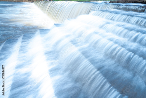 A pure white waterfall background formed in the river througha check dam