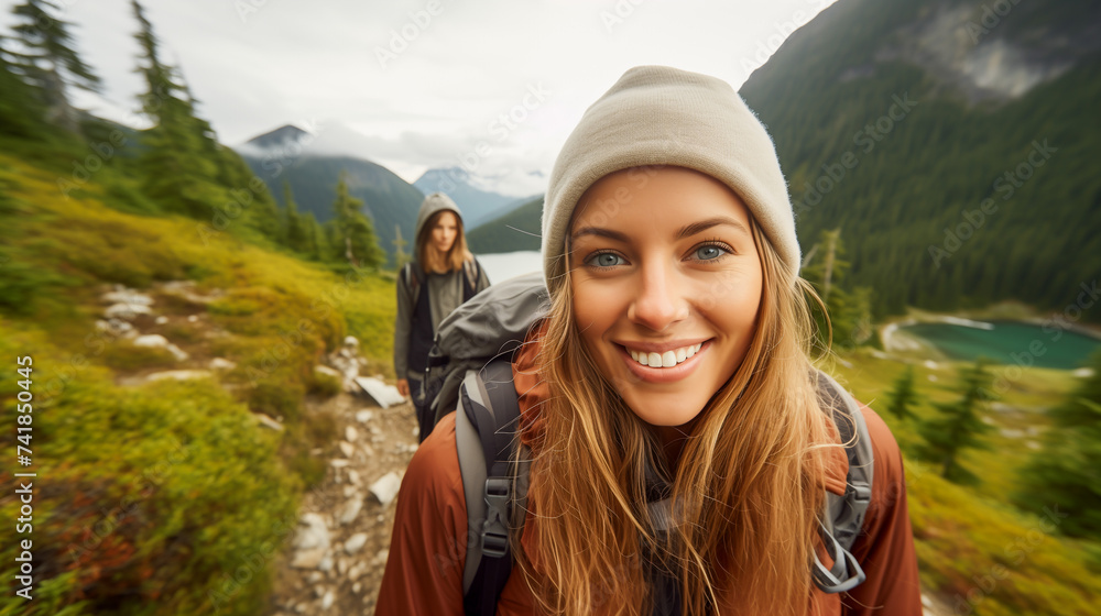 Young woman hiking in the mountains, her backpack slung over her shoulders. Portrait of nature lover woman.