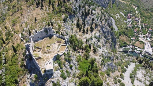 Fortress on a cliff, aerial drone view. Old castle on the hill, view from above. The Herceg Stjepan castle in Blagaj, Bosnia and Herzegovina.  photo