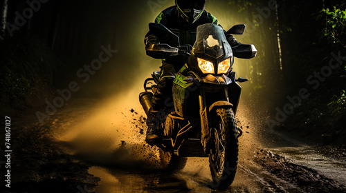 The motorcycle, shrouded in the haze of the night fog, stands on the wet road, like a mysterious