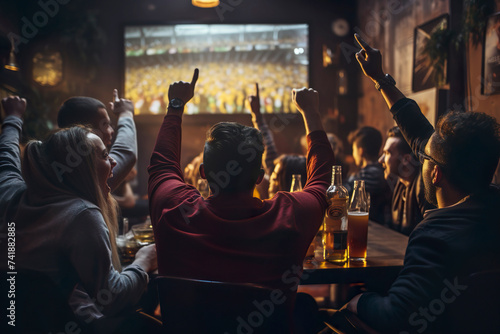 back, rear view of Group of young friends drinking beer watching football on tv green screen at sports bar. people watching a match in sports bar. fans watching a game in pub, celebrate goal mock up