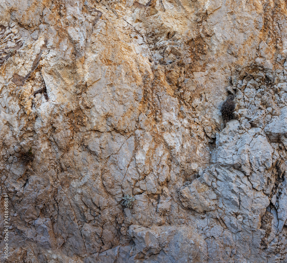 Weathered seaside rock face texture. Aged volcanic stone wall surface background pattern with cracks and scratches. Capri Island, Italy. Weathered seaside rock face texture. Aged volcanic stone wall surface background pattern with cracks and scratches. Capri Island, Italy.