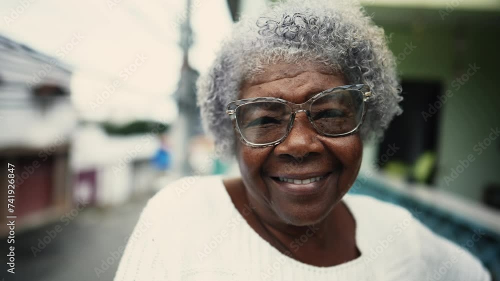 Portrait of Joyful 80s African Descent Senior Woman with Gray Hair on Balcony, close-up of South American elderly gray hair elderly person with friendly grin Portrait of Joyful 80s African Descent Senior Woman with Gray Hair on Balcony, close-up of South American elderly gray hair elderly person with friendly grin