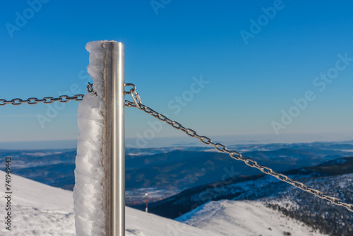 Steel railing tube with a chain, top of path to snezka from pink mountain, krkonose mountain, winter morning. photo