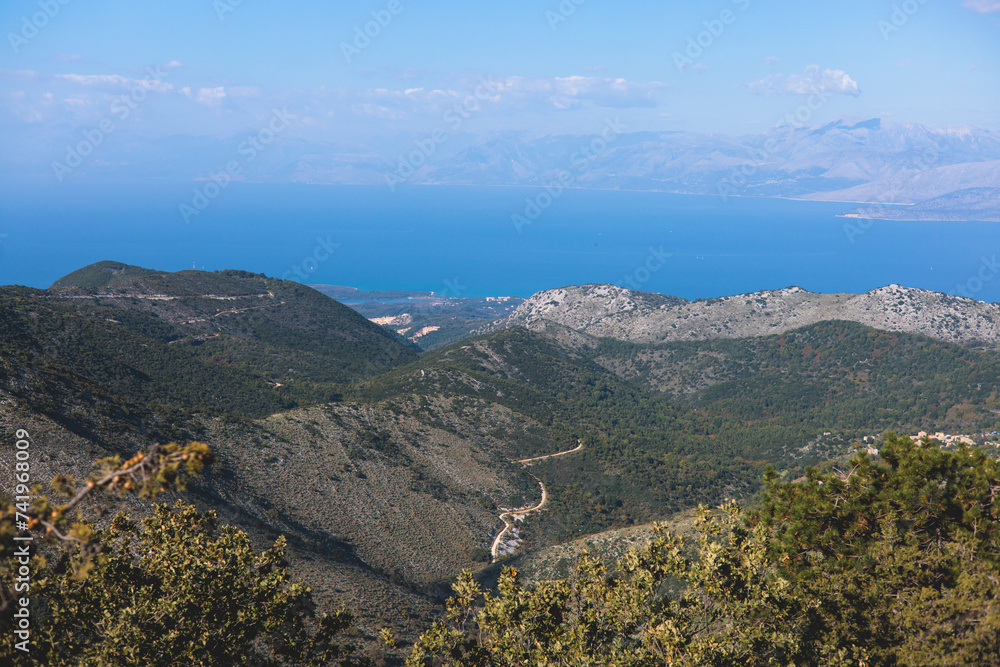 Mount Pantokrator vibrant landscape summit, Thinali, Corfu island, Kerkyra, Greece, summer sunny day, with monastery, a telecommunications station, Ionian sea and scenery beyond the island