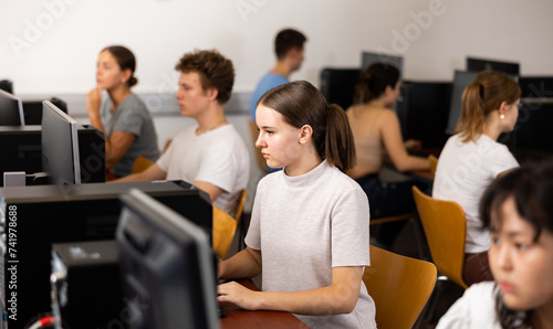 Teenager girl using computer during computer sciene lesson in school.