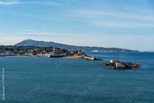 Panoramic view of the bay of Saint-Jean-de-Luz on the south coast of France on a sunny day with a calm sea. photo