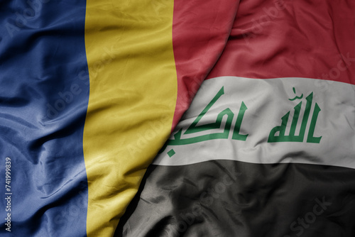 big waving national colorful flag of iraq and national flag of romania .