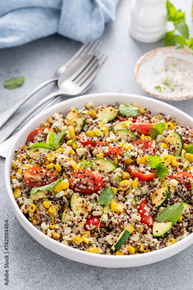 Quinoa salad with vegetables and herbs in a serving bowl Quinoa salad with vegetables and herbs in a serving bowl