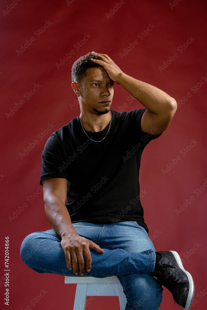 Portrait young African man posing touching his hair