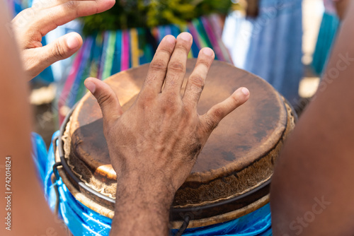 Percussionist hands playing atabaque. photo