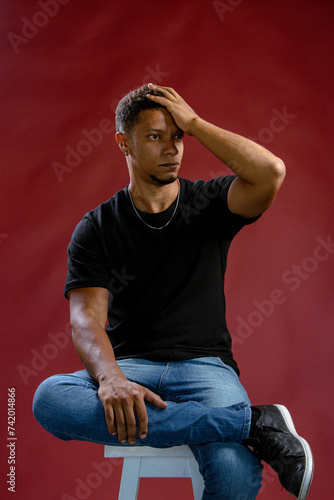 Portrait young African man posing touching his hair