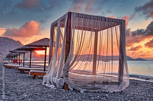 Canopy for beach loungers with curtains and parasols, sunrise, beach, Rhodes, Greece, Europe photo
