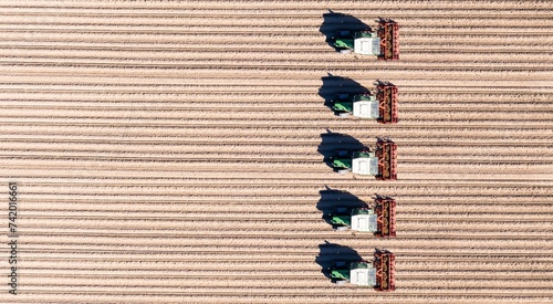 Aerial view of tractors ploughing fields in the agricultural sector, e.g. asparagus, Bergstrasse, Hesse, Germany, Europe photo