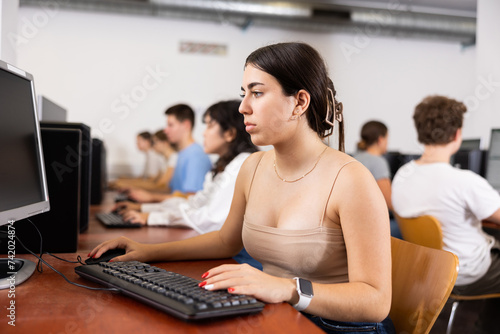 Teenager girl using computer during computer sciene lesson in school.